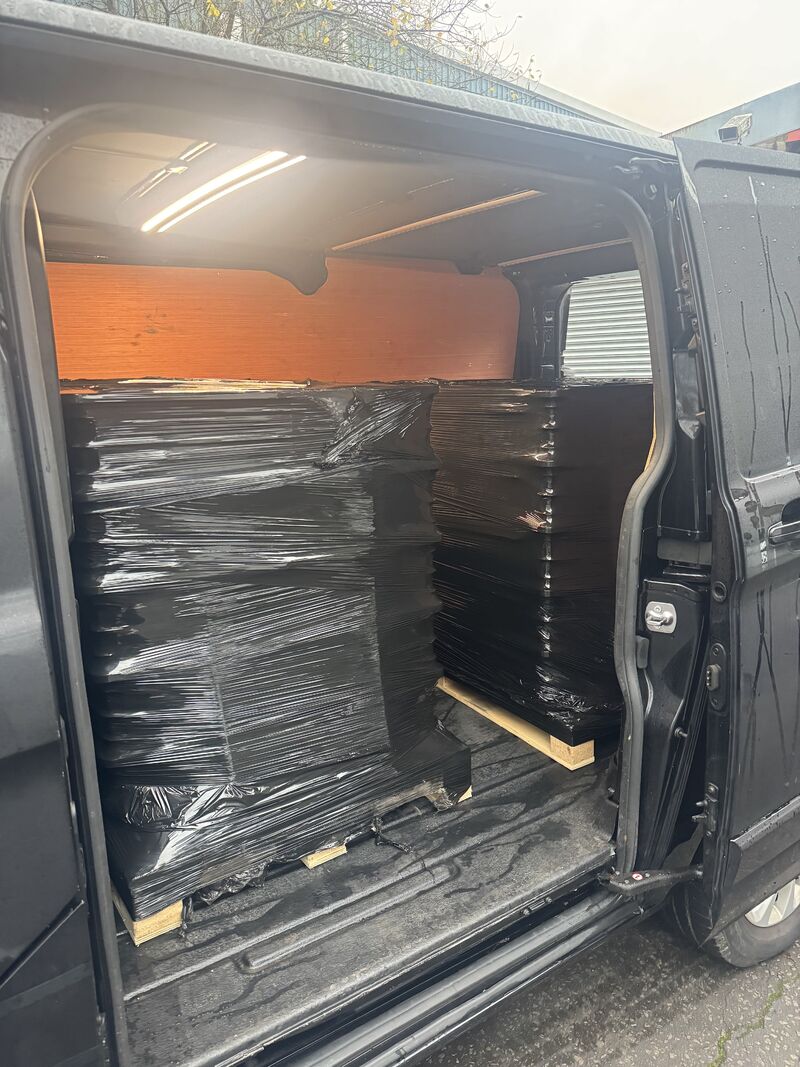 Reusable blue Knect bins being loaded into a delivery van
